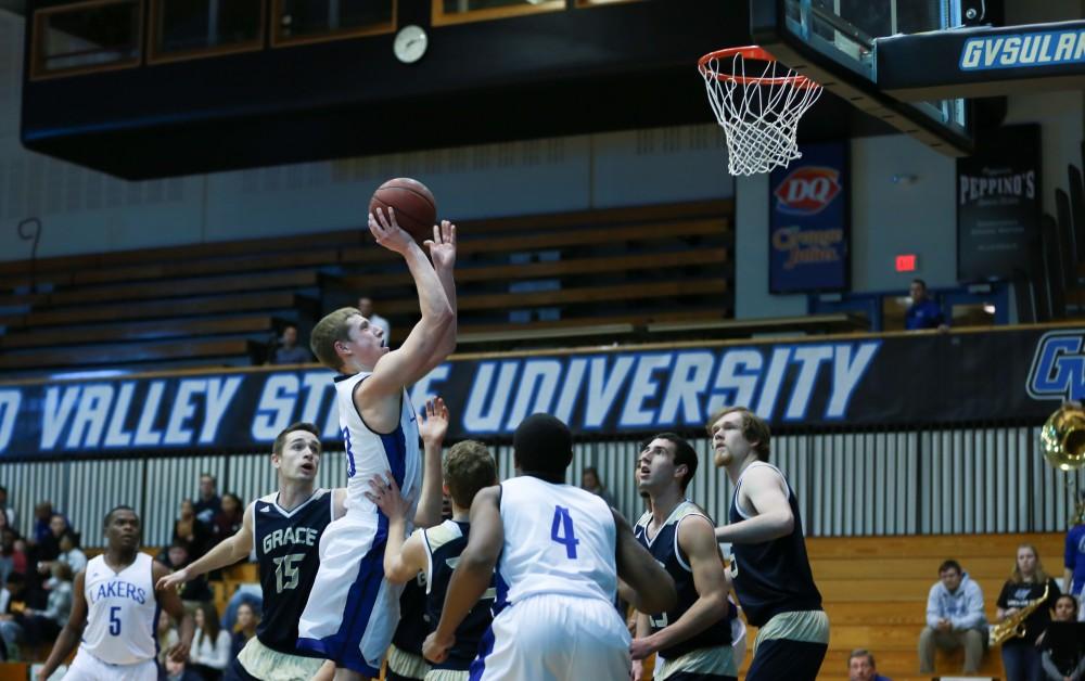 GVL / Kevin Sielaff - Luke Ryskamp (23) tries a floater toward the net.  The Laker basketball squad defeats Grace Bible College with a final score of 83-57 Nov. 23 in the fieldhouse arena.