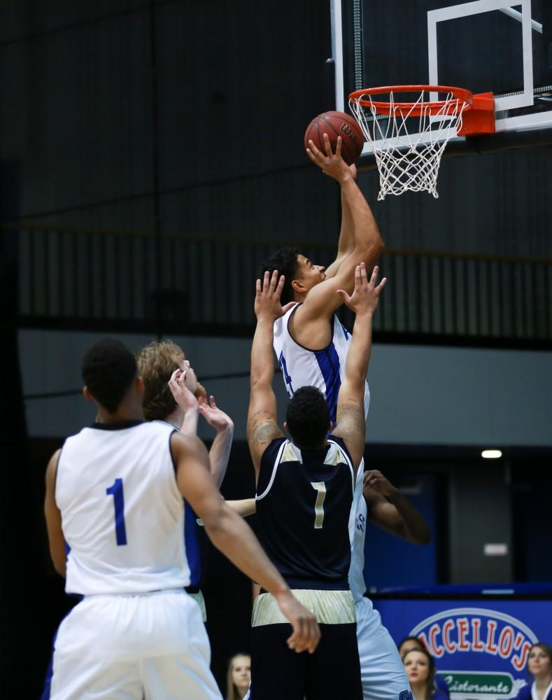 GVL / Kevin Sielaff - Justin Greason (24) drives the ball in for a lay-up.  The Laker basketball squad defeats Grace Bible College with a final score of 83-57 Nov. 23 in the fieldhouse arena.