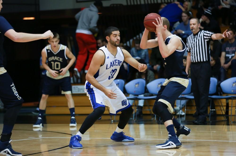 GVL / Kevin Sielaff - Ricardo Carbajal (32) defends a Grace Bible attack.  The Laker basketball squad defeats Grace Bible College with a final score of 83-57 Nov. 23 in the fieldhouse arena.