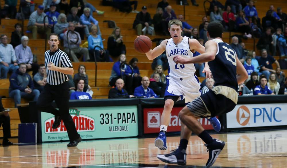 GVL / Kevin Sielaff - Luke Ryskamp (23) takes on a Grace Bible defender on a break away.  The Laker basketball squad defeats Grace Bible College with a final score of 83-57 Nov. 23 in the fieldhouse arena.