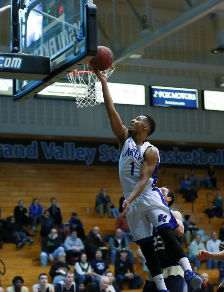 GVL / Kevin Sielaff - Aaron Hayes (1) rolls the ball off of his fingers and into the hoop.  The Laker basketball squad defeats Grace Bible College with a final score of 83-57 Nov. 23 in the fieldhouse arena.