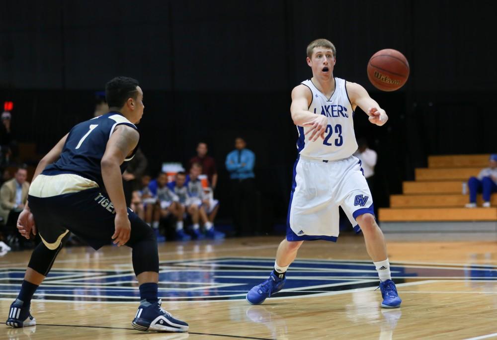 GVL / Kevin Sielaff - Luke Ryskamp (23) moves the ball around the arch.  The Laker basketball squad defeats Grace Bible College with a final score of 83-57 Nov. 23 in the fieldhouse arena.