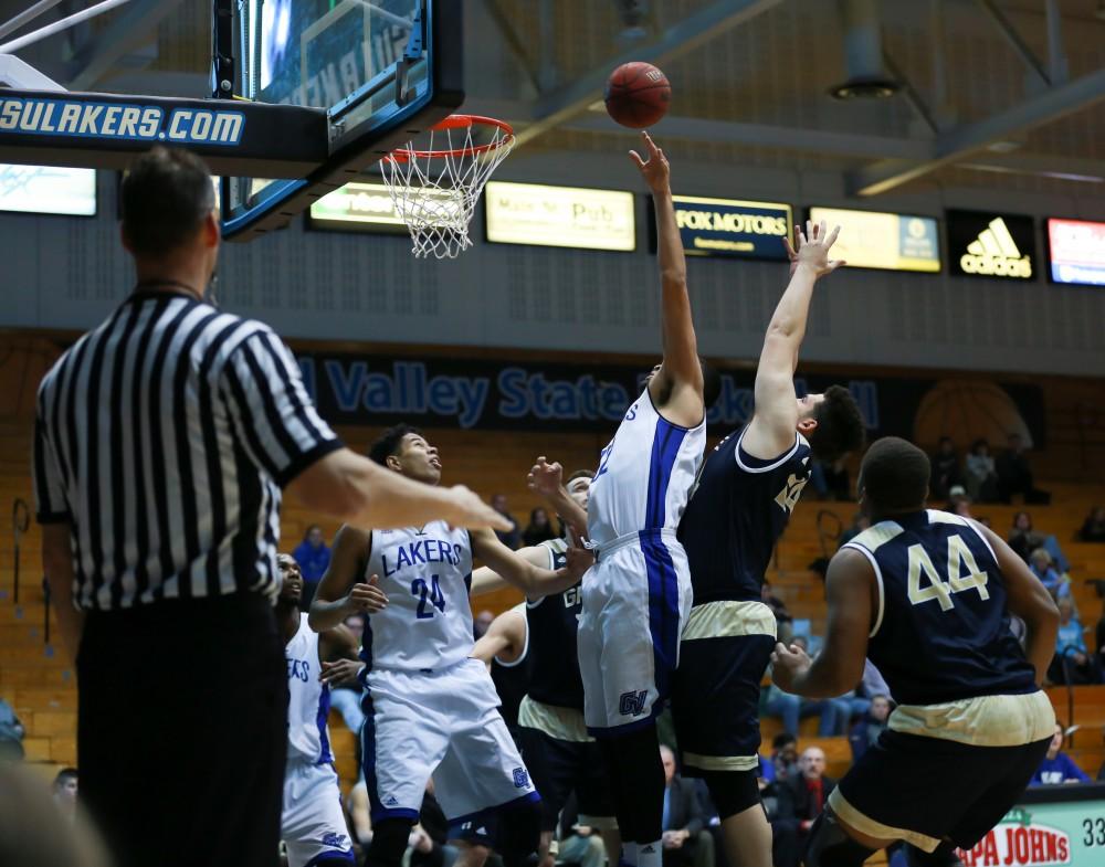 GVL / Kevin Sielaff - Ricardo Carbajal (32) rises up to grab an offensive board.  The Laker basketball squad defeats Grace Bible College with a final score of 83-57 Nov. 23 in the fieldhouse arena.