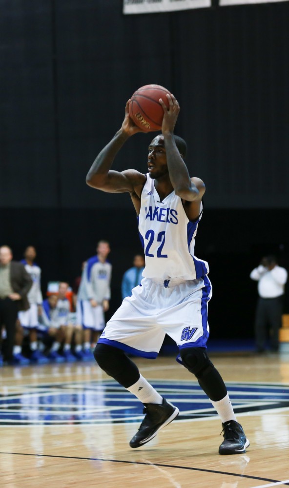 GVL / Kevin Sielaff - Juwan Starks (22) fakes a shot.  The Laker basketball squad defeats Grace Bible College with a final score of 83-57 Nov. 23 in the fieldhouse arena.