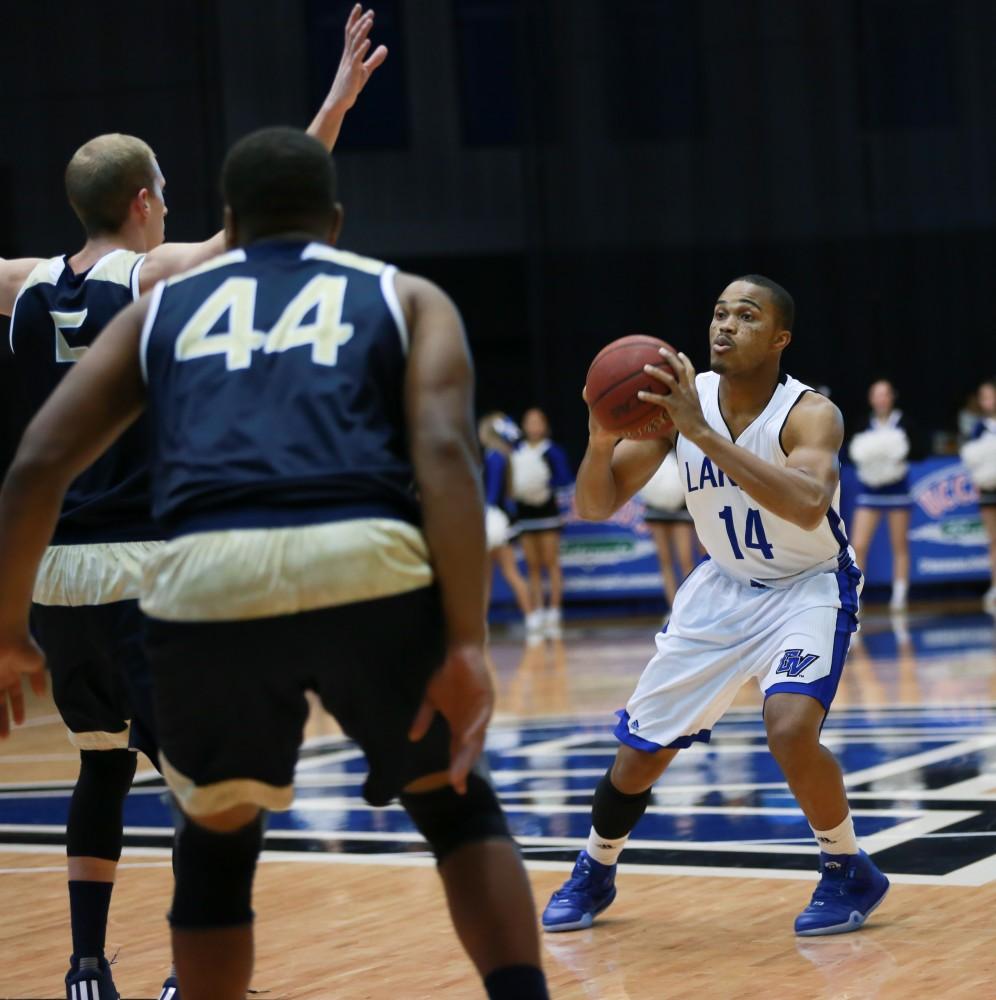 GVL / Kevin Sielaff - Harold Wiggins (14) fakes a shot.  The Laker basketball squad defeats Grace Bible College with a final score of 83-57 Nov. 23 in the fieldhouse arena.