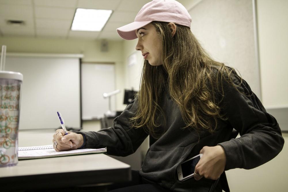 GVL / Sara Carte
Grand Valley student, Alison Farnsworth, hides her phone while in class at Lake Superior Hall on Oct. 27.