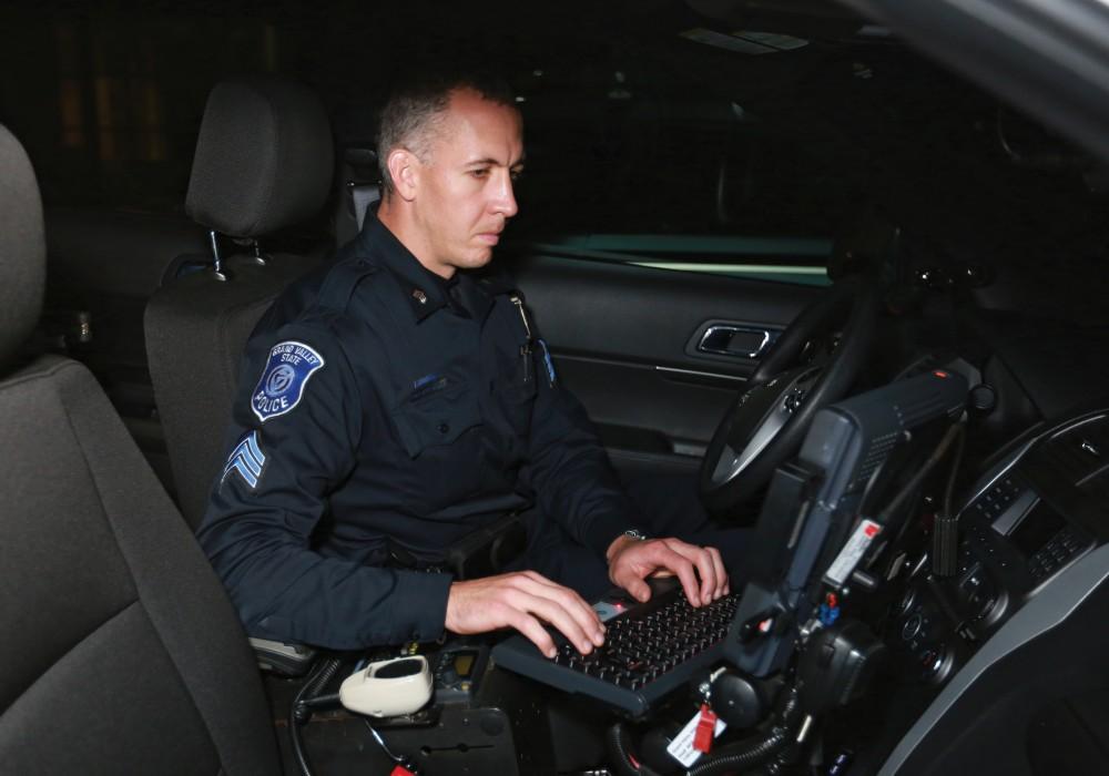 GVL / Kevin Sielaff - Sgt. Jeff Stoll wraps up the night shift by entering reports into his in-car computer on Oct. 25.