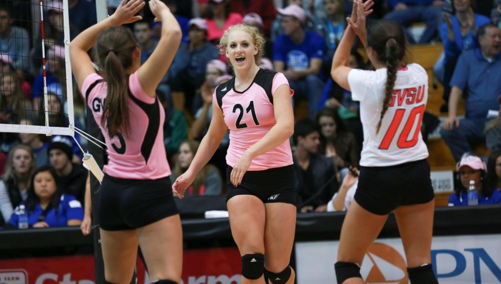 GVL / Kevin Sielaff - Staci Brower (21) celebrates with her teammates after a point scored. Grand Valley squares off against Ohio Dominican and claims the victory with a final score of 3-1.