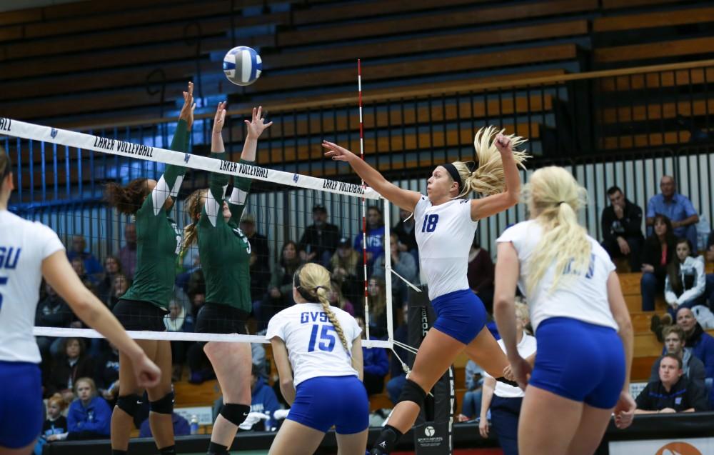 GVL / Kevin Sielaff - Shannon Winicki (18) tips the ball over the net. Grand Valley sweeps Tiffin Oct. 3 after three sets inside the Fieldhouse Arena in Allendale.