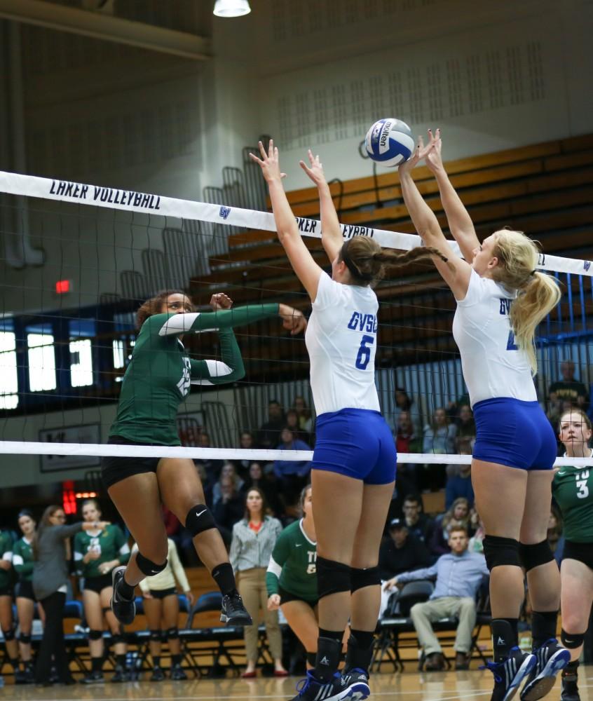 GVL / Kevin Sielaff - Staci Brower (21) gets a hand on the ball to prevent a Tiffin point. Grand Valley sweeps Tiffin Oct. 3 after three sets inside the Fieldhouse Arena in Allendale.