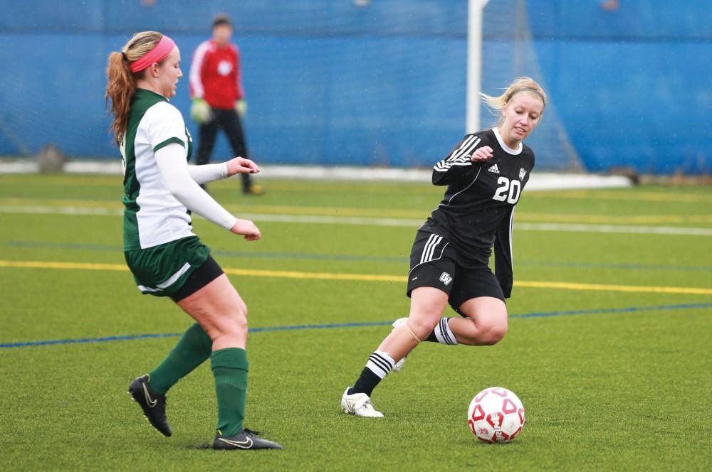GVL / Kevin Sielaff - Jenny Winters (20) runs to intercept a State pass.  Grand Valleys womens club soccer team squares off against Michigan State on a rainy Oct. 31. The Lakers were defeated, with a final score of 2-0 in favor of Michigan State.