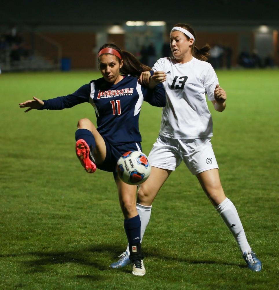 GVL / Kevin Sielaff - Marti Corby (13) battles with Malone's Corrin Hayberg (11).  Grand Valley defeats Malone in the first round of the GLIAC tournament with a final score of 6-0 Nov. 4 in Allendale.