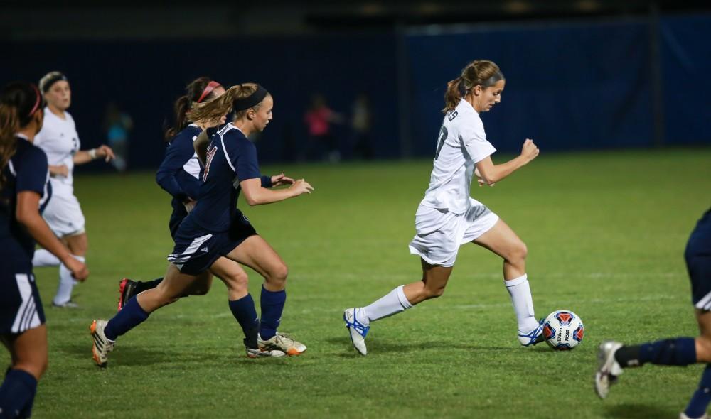 GVL / Kevin Sielaff - Gabriella Mencotti (20) races to evade Malone defenders.  Grand Valley defeats Malone in the first round of the GLIAC tournament with a final score of 6-0 Nov. 4 in Allendale.