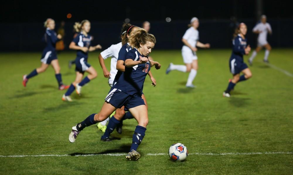 GVL / Kevin Sielaff - Malone's Leah Arnold (18) carries the ball toward midfield.  Grand Valley defeats Malone in the first round of the GLIAC tournament with a final score of 6-0 Nov. 4 in Allendale.