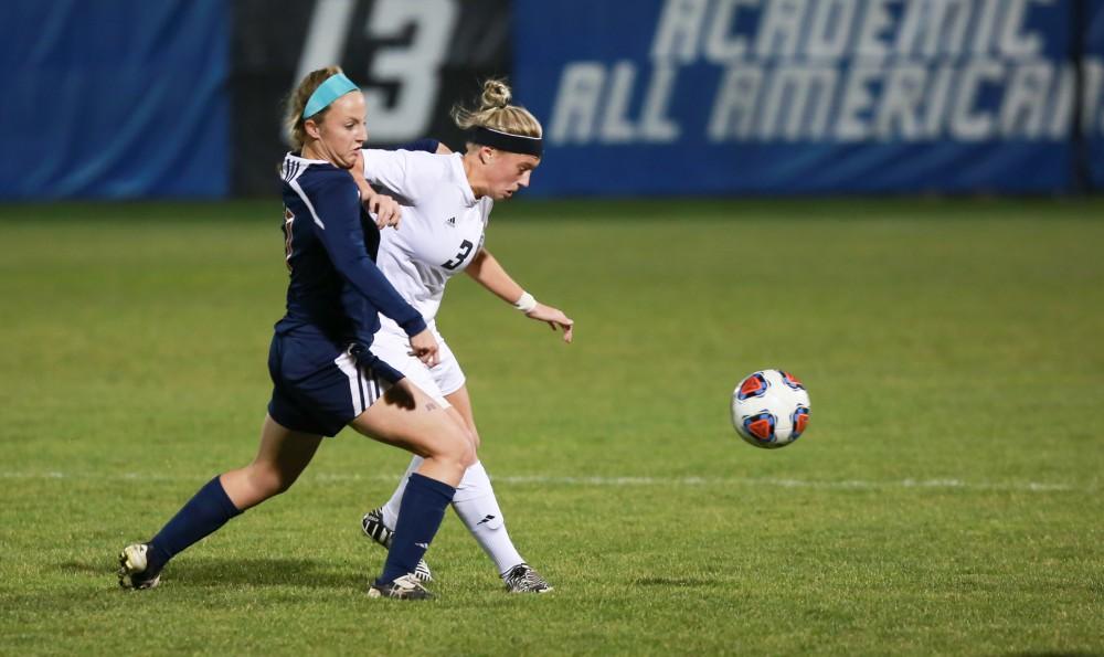 GVL / Kevin Sielaff - Gabbie Guibord (3) fights for position with a Malone attacker.  Grand Valley defeats Malone in the first round of the GLIAC tournament with a final score of 6-0 Nov. 4 in Allendale.