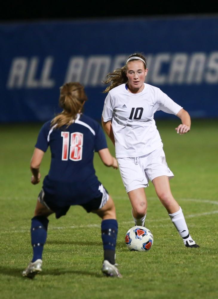 GVL / Kevin Sielaff - Shannon Quinn (10) jukes around Leah Arnold (18) of Malone.  Grand Valley defeats Malone in the first round of the GLIAC tournament with a final score of 6-0 Nov. 4 in Allendale.