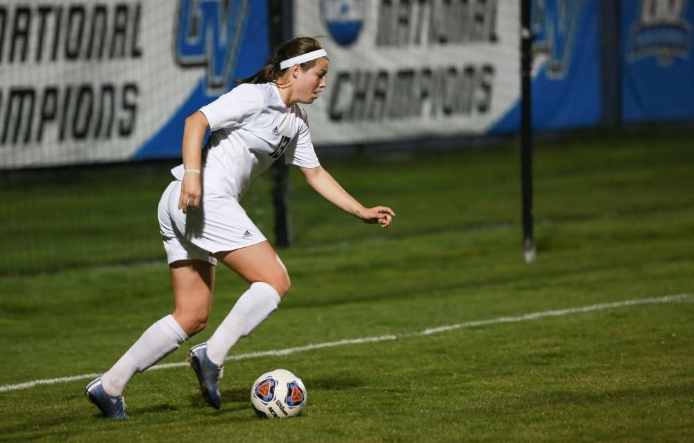 GVL / Kevin Sielaff - Marti Corby (13) sets up a cross.  Grand Valley defeats Malone in the first round of the GLIAC tournament with a final score of 6-0 Nov. 4 in Allendale.