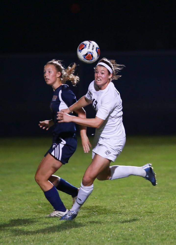 GVL / Kevin Sielaff - Marti Corby (13) fights her way toward the opposing net.  Grand Valley defeats Malone in the first round of the GLIAC tournament with a final score of 6-0 Nov. 4 in Allendale.