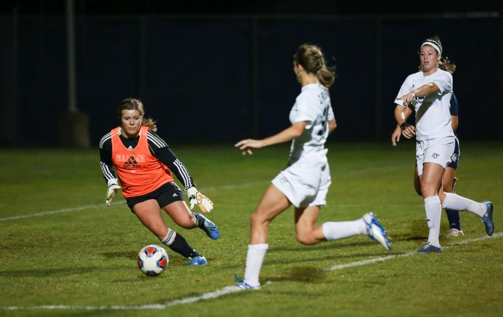 GVL / Kevin Sielaff - Gabriella Mencotti (20) tries a shot, but it is blocked.  Grand Valley defeats Malone in the first round of the GLIAC tournament with a final score of 6-0 Nov. 4 in Allendale.