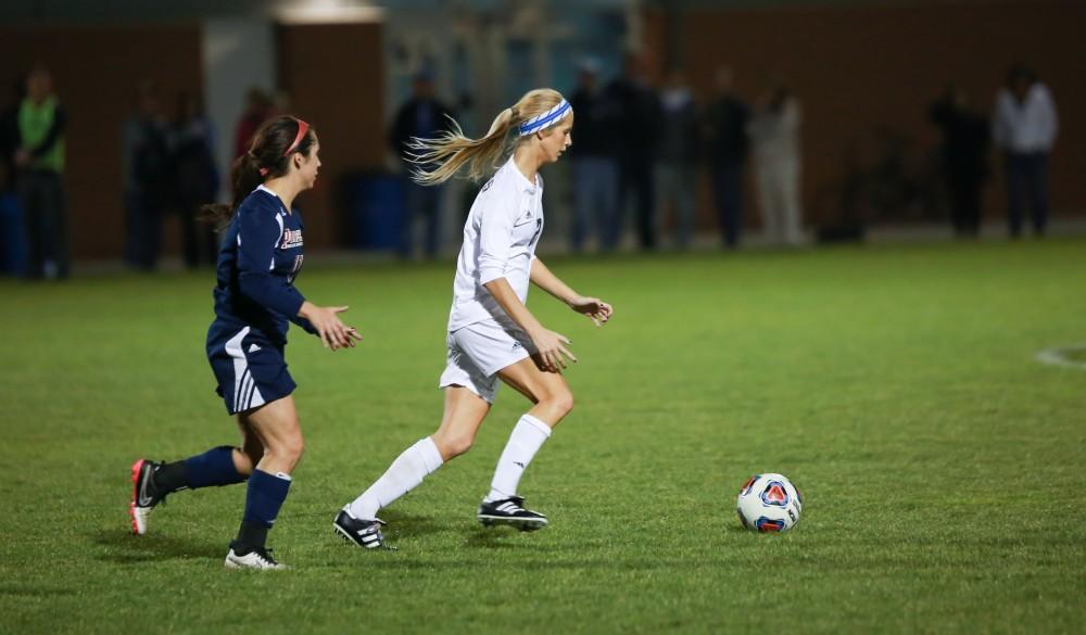 GVL / Kevin Sielaff - Katie Klunder (20) dribbles the ball around midfield.  Grand Valley defeats Malone in the first round of the GLIAC tournament with a final score of 6-0 Nov. 4 in Allendale.