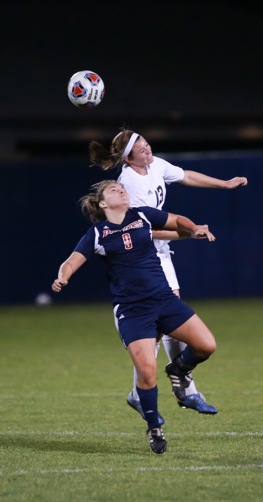 GVL / Kevin Sielaff - Marti Corby (13) heads the ball.  Grand Valley defeats Malone in the first round of the GLIAC tournament with a final score of 6-0 Nov. 4 in Allendale.