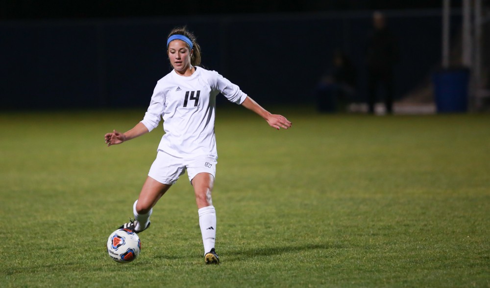 GVL / Kevin Sielaff - Mackenzie Fox (14) passes the ball toward the opposing net.  Grand Valley defeats Malone in the first round of the GLIAC tournament with a final score of 6-0 Nov. 4 in Allendale.