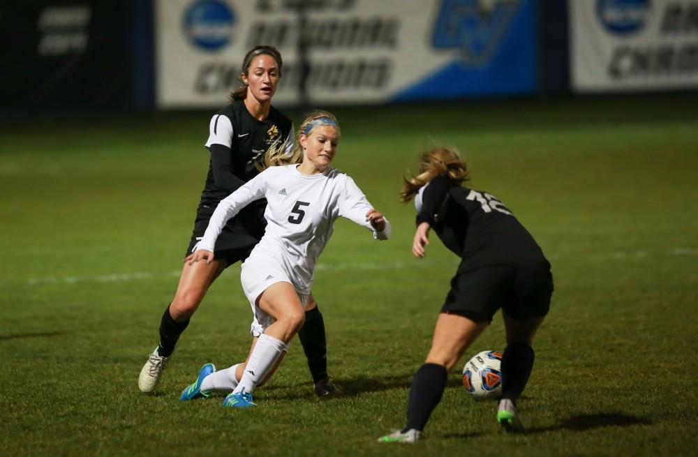 GVL / Kevin Sielaff  - Kendra Stauffer (5) splits the Dominican defense.  Grand Valley defeats Ohio Dominican 3-0 in the semi-finals of the GLIAC tournament Nov. 6 in Allendale.