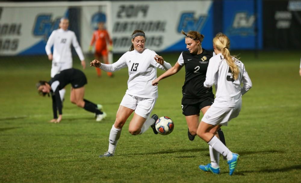 GVL / Kevin Sielaff - Marti Corby (13) fights for the ball around mid field.  Grand Valley defeats Ohio Dominican 3-0 in the semi-finals of the GLIAC tournament Nov. 6 in Allendale.