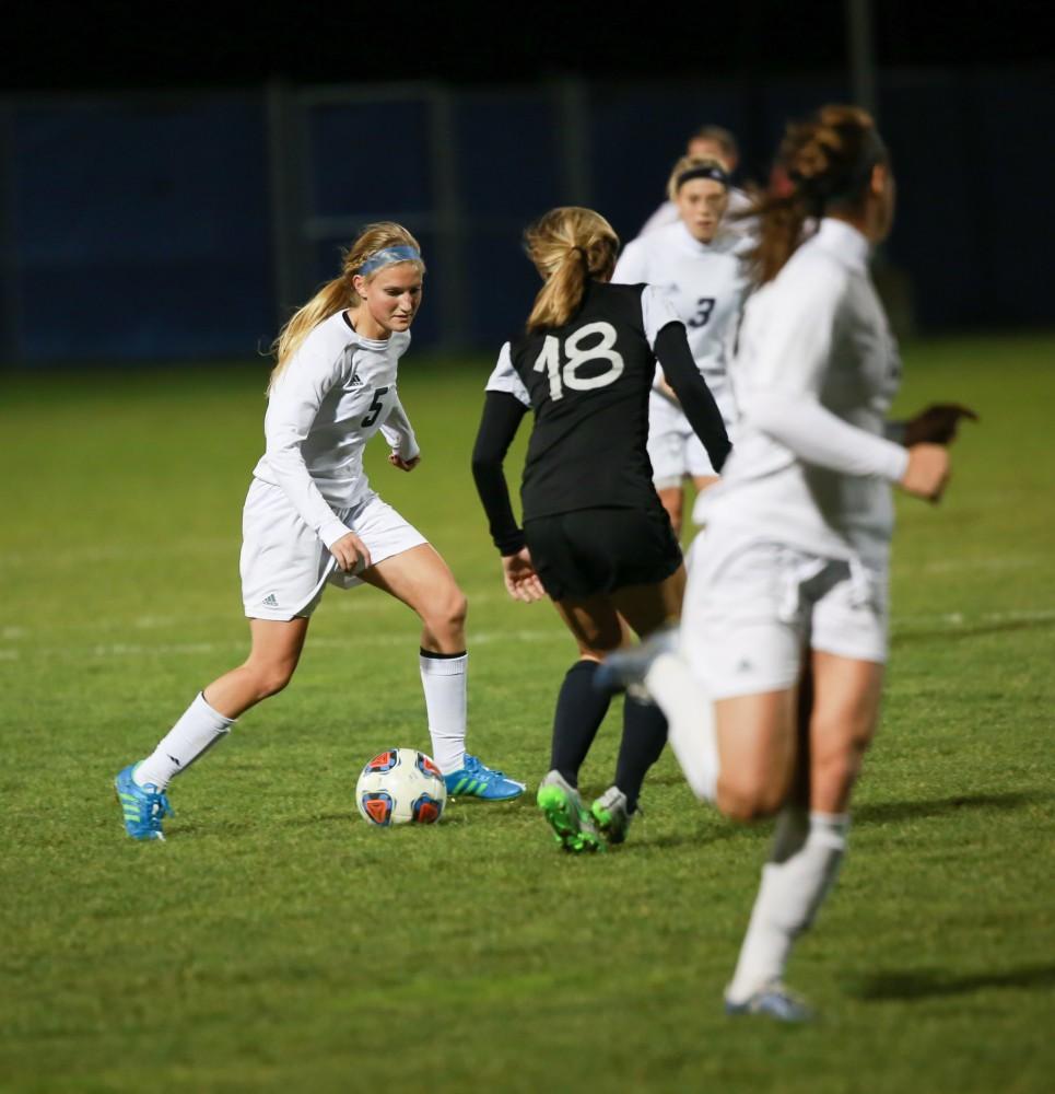 GVL / Kevin Sielaff - Kendra Stuaffer (5) looks to pass the ball off to Marti Corby (13).  Grand Valley defeats Ohio Dominican 3-0 in the semi-finals of the GLIAC tournament Nov. 6 in Allendale.