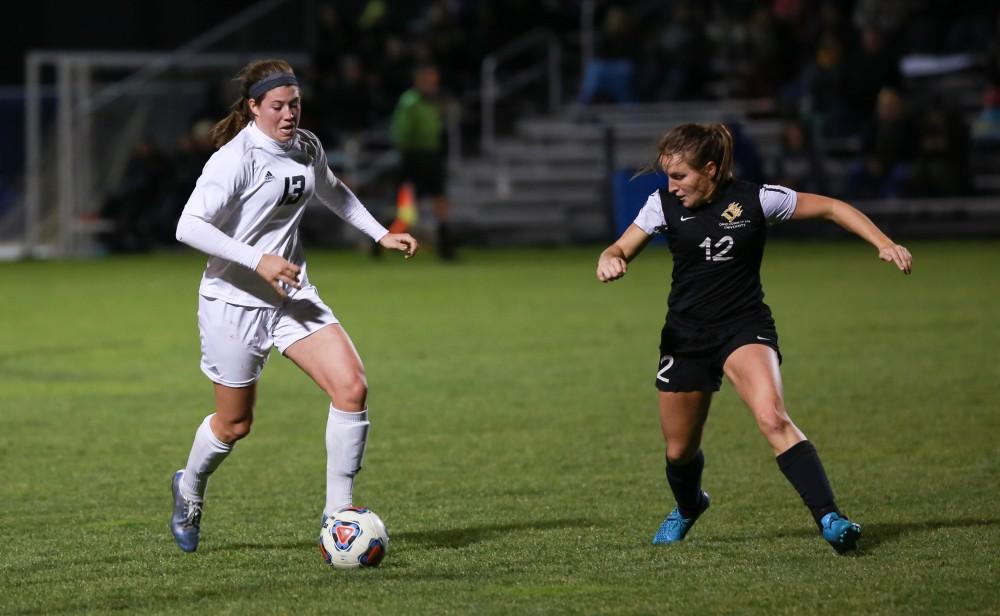 GVL / Kevin Sielaff - Marti Corby (13) challenges the Dominican defense.  Grand Valley defeats Ohio Dominican 3-0 in the semi-finals of the GLIAC tournament Nov. 6 in Allendale.