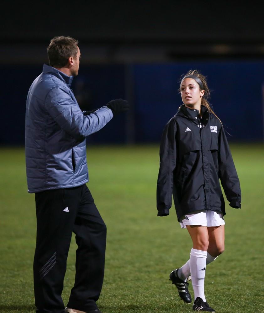 GVL / Kevin Sielaff -  Mackenzie Fox (14) speaks with head coach Jeff Hosler.  Grand Valley defeats Ohio Dominican 3-0 in the semi-finals of the GLIAC tournament Nov. 6 in Allendale.