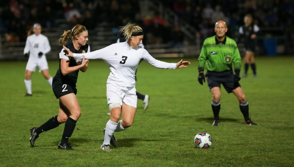 GVL / Kevin Sielaff - Gabbie Guibord (3) fights to stay on her feet as she is tugged down by the Dominican offense.  Grand Valley defeats Ohio Dominican 3-0 in the semi-finals of the GLIAC tournament Nov. 6 in Allendale.