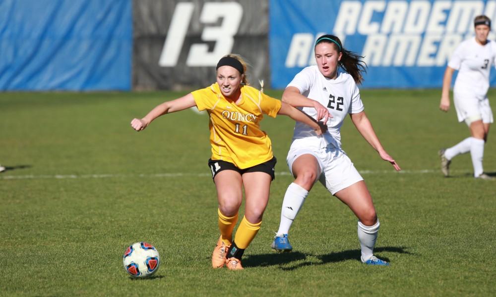 GVL / Kevin Sielaff - Samantha Riga (22) battles with Quincy's Allison Birke (11).   Grand Valley squares off against Quincy in the second round of the women's soccer NCAA tournament Nov. 15 in Allendale. The Lakers take the victory with a final score of 6-0.