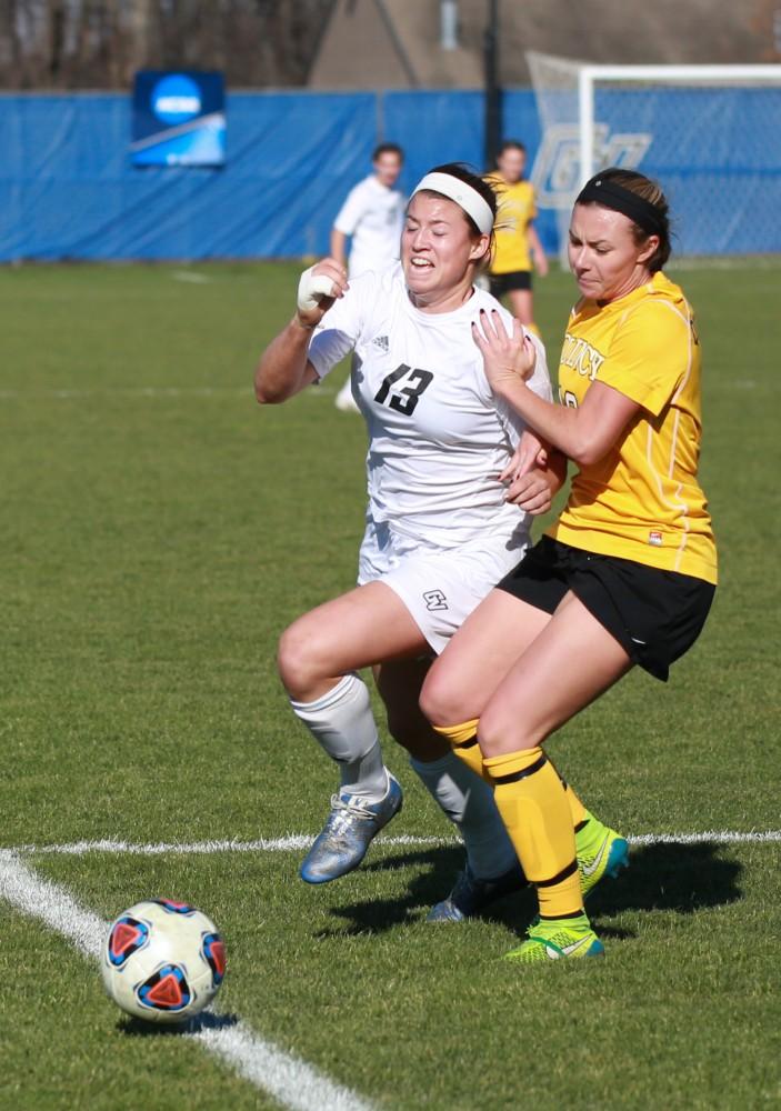 GVL / Kevin Sielaff - Marti Corby (13) powers through to the opposing net.  Grand Valley squares off against Quincy in the second round of the women's soccer NCAA tournament Nov. 15 in Allendale. The Lakers take the victory with a final score of 6-0.