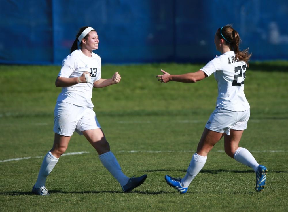 GVL / Kevin Sielaff - Marti Corby (13) and Samantha Riga (22) celebrate a goal.  Grand Valley squares off against Quincy in the second round of the women's soccer NCAA tournament Nov. 15 in Allendale. The Lakers take the victory with a final score of 6-0.