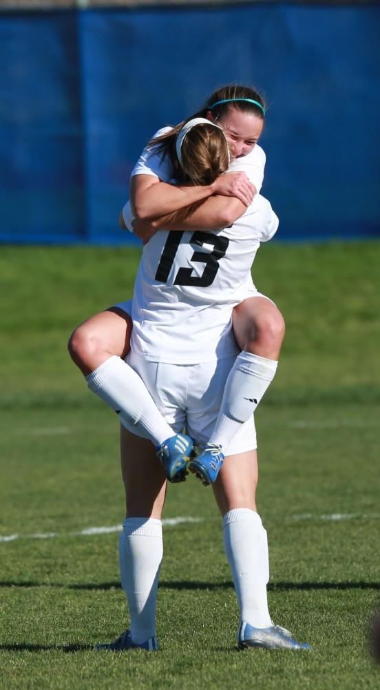 GVL / Kevin Sielaff - Marti Corby (13) and Samantha Riga (22) celebrate a goal.  Grand Valley squares off against Quincy in the second round of the women's soccer NCAA tournament Nov. 15 in Allendale. The Lakers take the victory with a final score of 6-0.