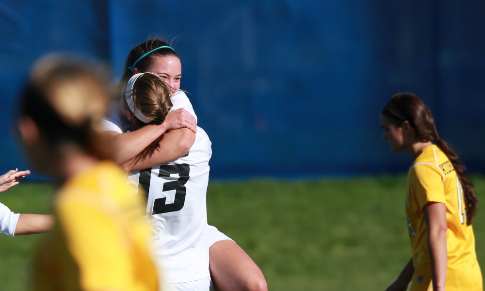 GVL / Kevin Sielaff - Marti Corby (13) and Samantha Riga (22) celebrate a goal.  Grand Valley squares off against Quincy in the second round of the women's soccer NCAA tournament Nov. 15 in Allendale. The Lakers take the victory with a final score of 6-0.