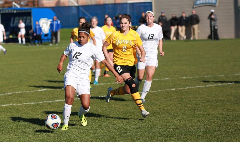 GVL / Kevin Sielaff - Jayma Martin (12) moves the ball within the box in Quincy's zone.  Grand Valley squares off against Quincy in the second round of the women's soccer NCAA tournament Nov. 15 in Allendale. The Lakers take the victory with a final score of 6-0.