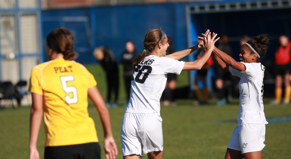 GVL / Kevin Sielaff - Gabriella Mencotti (20) celebrates her goal with Jayma Martin (12). Grand Valley squares off against Quincy in the second round of the women's soccer NCAA tournament Nov. 15 in Allendale. The Lakers take the victory with a final score of 6-0.