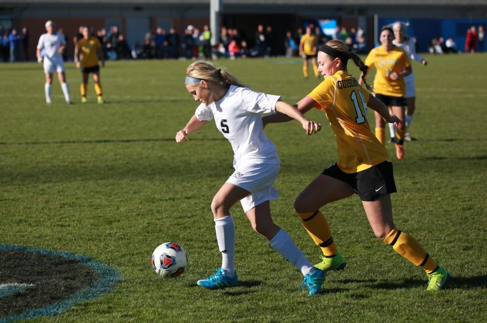 GVL / Kevin Sielaff - Kendra Stauffer (5) fends off a Quincy attacker.  Grand Valley squares off against Quincy in the second round of the women's soccer NCAA tournament Nov. 15 in Allendale. The Lakers take the victory with a final score of 6-0.