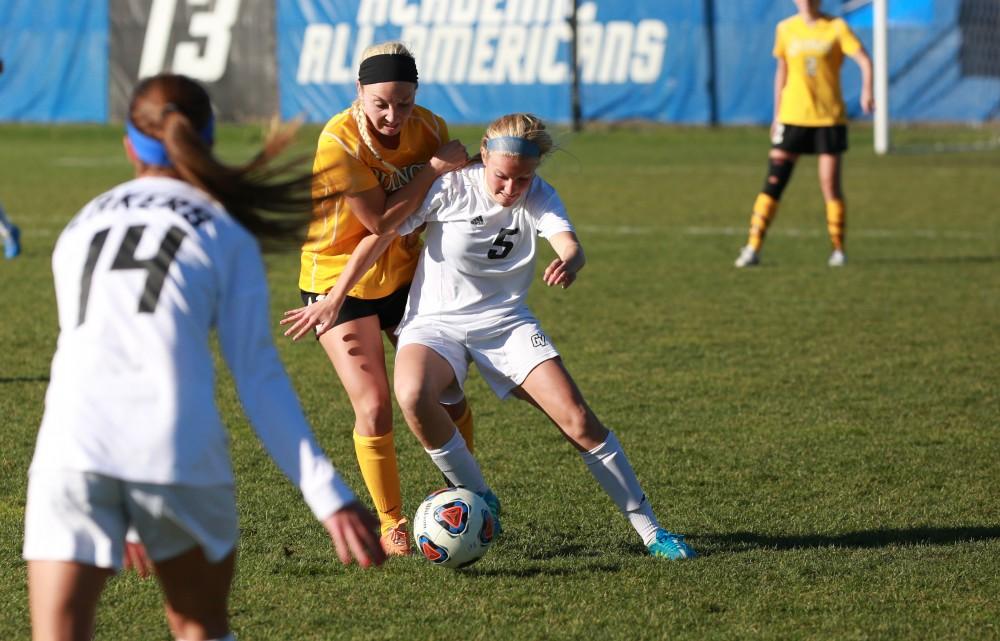 GVL / Kevin Sielaff - Kendra Stauffer (5) fends off a quincy attacker.  Grand Valley squares off against Quincy in the second round of the womens soccer NCAA tournament Nov. 15 in Allendale. The Lakers take the victory with a final score of 6-0.