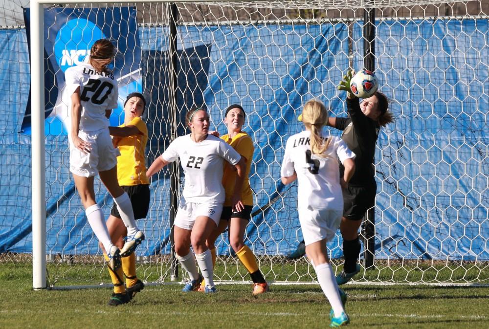 GVL / Kevin Sielaff - Gabriella Mencotti (20) tries a shot on net, but it is blocked by Quincy's goaltender.  Grand Valley squares off against Quincy in the second round of the women's soccer NCAA tournament Nov. 15 in Allendale. The Lakers take the victory with a final score of 6-0.