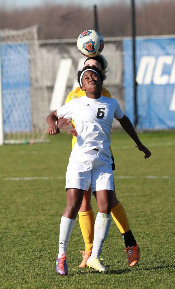 GVL / Kevin Sielaff - Katie Bounds (6) heads the ball over the Quincy defense.  Grand Valley squares off against Quincy in the second round of the women's soccer NCAA tournament Nov. 15 in Allendale. The Lakers take the victory with a final score of 6-0.