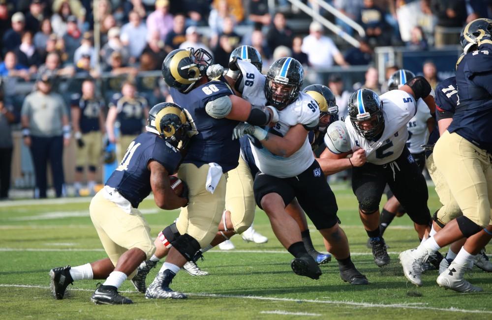 GVL / Kevin Sielaff - Mark Rosenquist (96) pushes his way through Shepard's defense.  The Lakers fall to the Rams of Shepard University with a final score of 34-32 Dec. 12 in Shepardstown, West Virginia.