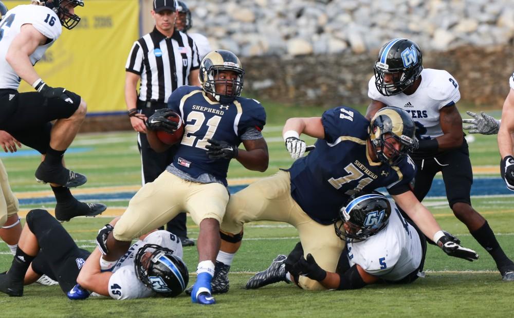 GVL / Kevin Sielaff - Shepard's Jabre Lolley (21) powers through Grand Valley's defense.  The Lakers fall to the Rams of Shepard University with a final score of 34-32 Dec. 12 in Shepardstown, West Virginia.