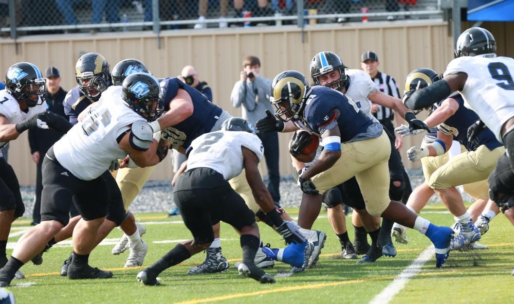 GVL / Kevin Sielaff - Shepard's Jabre Lolley (21) continues to run the ball against Grand Valley.  The Lakers fall to the Rams of Shepard University with a final score of 34-32 Dec. 12 in Shepardstown, West Virginia.