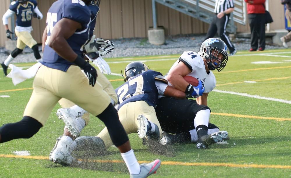 GVL / Kevin Sielaff - Matt Williams (24) receives a catch, but it downed by Shepard's CJ Davis (27).  The Lakers fall to the Rams of Shepard University with a final score of 34-32 Dec. 12 in Shepardstown, West Virginia.