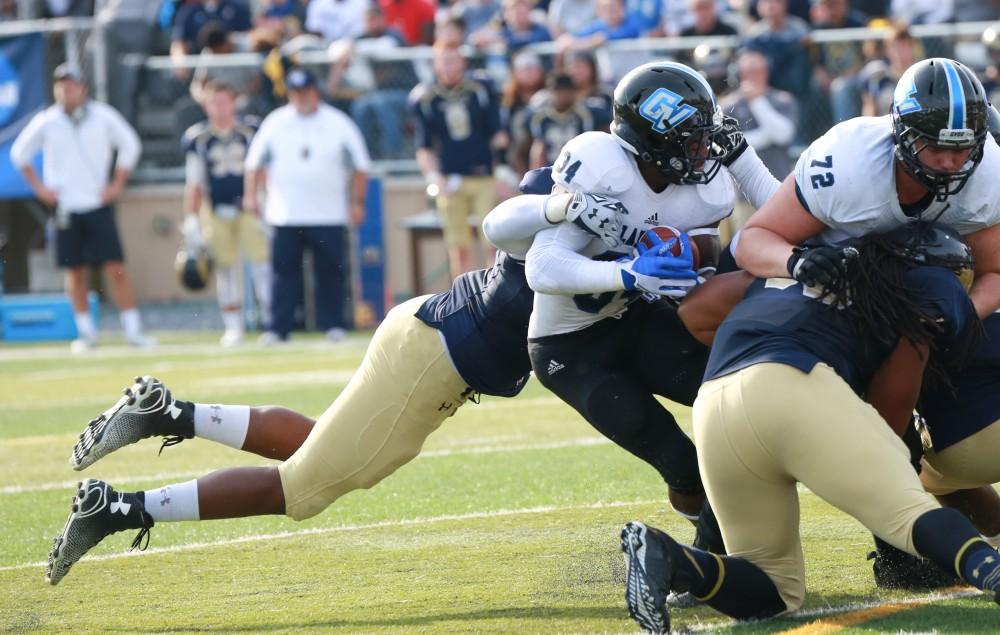 GVL / Kevin Sielaff - Marty Carter (34) is tackled as he attempts to penetrate the Shepard defensive line.  The Lakers fall to the Rams of Shepard University with a final score of 34-32 Dec. 12 in Shepardstown, West Virginia.