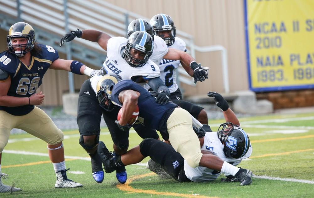 GVL / Kevin Sielaff - Matt Judon (9) gets in on the Shepard defense to stop a run.  The Lakers fall to the Rams of Shepard University with a final score of 34-32 Dec. 12 in Shepardstown, West Virginia.