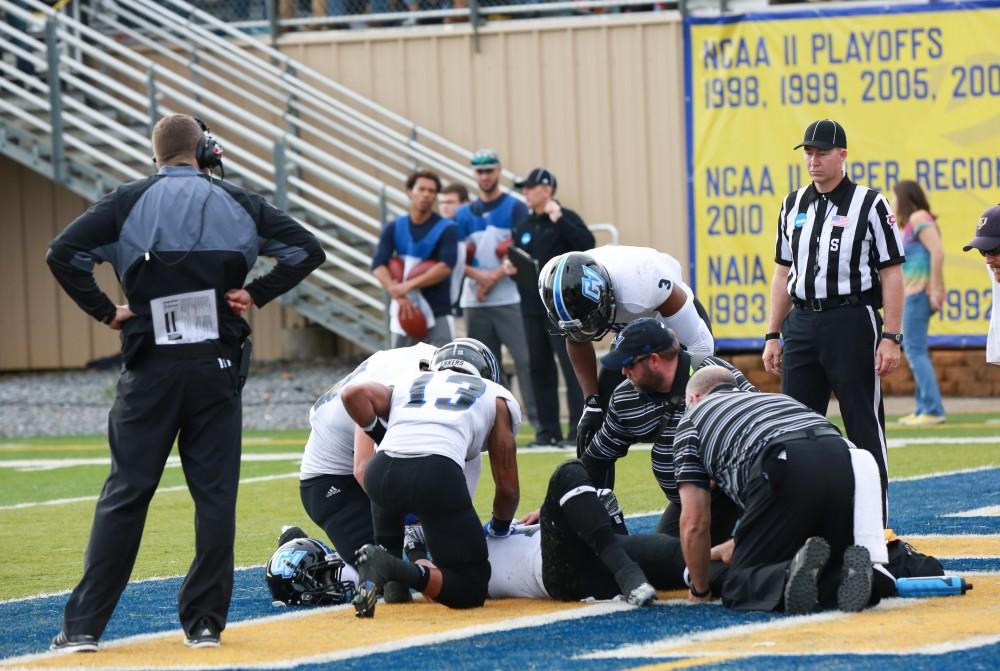 GVL / Kevin Sielaff - Jamie Potts (15), injured in the end zone, is helped up by his teammates.  The Lakers fall to the Rams of Shepard University with a final score of 34-32 Dec. 12 in Shepardstown, West Virginia.